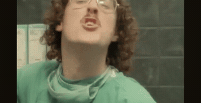 Man With Curly Hair And Glasses In Surgical Gown And Mask GIF