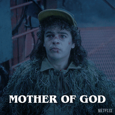 Man With Curly Hair And Hat In Fur Coat GIF