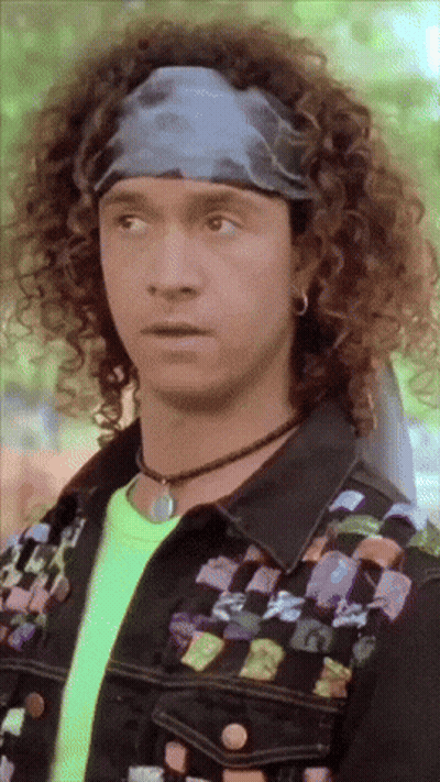 Man With Curly Hair And Neon Shirt GIF