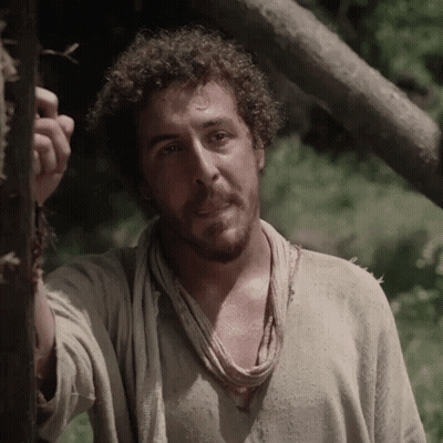Man With Curly Hair And Scarf Next To Tree GIF