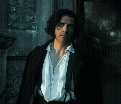 Man With Curly Hair And Suspenders In Front Of Building GIF