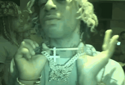 Man With Curly Hair Cross Necklace Smoking GIF