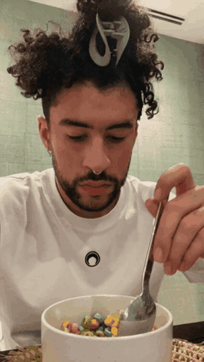 Man With Curly Hair Eating Cereal With Spoon GIF