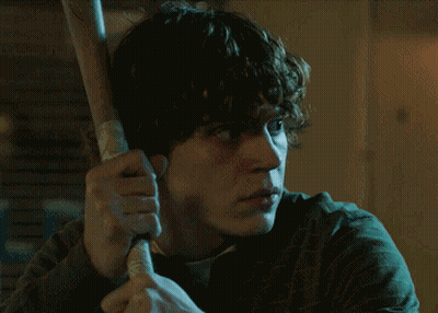 Man With Curly Hair Holding Baseball Bat GIF