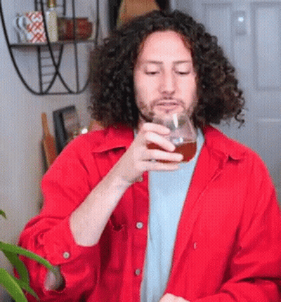 Man With Curly Hair Holding Beer GIF