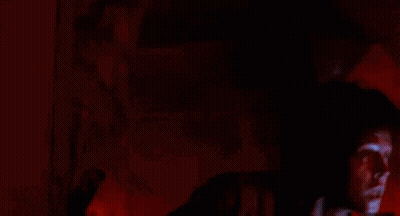 Man With Curly Hair Holding Flashlight GIF