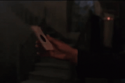 Man With Curly Hair Holding Paper GIF