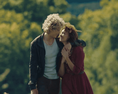 Man With Curly Hair Hugging Woman In Red Dress GIF