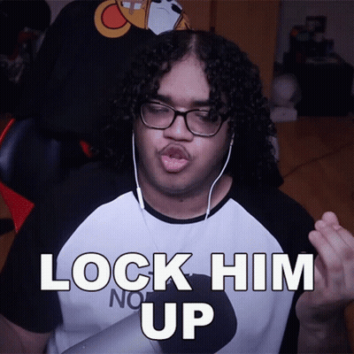 Man With Curly Hair In Headphones And Lock Him Up Shirt GIF