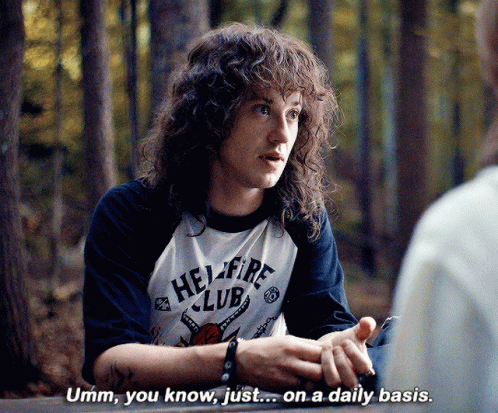 Man With Curly Hair In Hellfire Club Shirt GIF