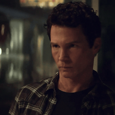 Man With Curly Hair In Plaid And Black Shirt GIF