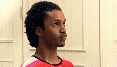 Man With Curly Hair In Red And Pink Striped Shirt And Earrings GIF