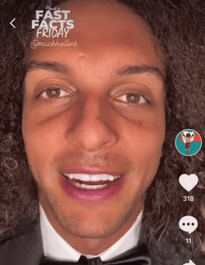 Man With Curly Hair In Suit And Bow Tie GIF