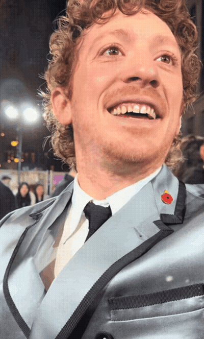 Man With Curly Hair In Suit And Tie GIF