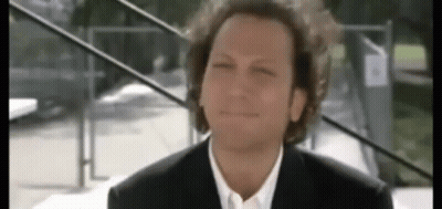 Man With Curly Hair In Suit And Tie GIF