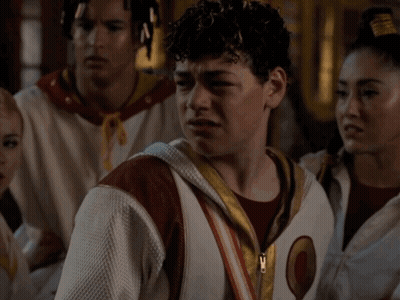 Man With Curly Hair In White Jacket With Letter O GIF