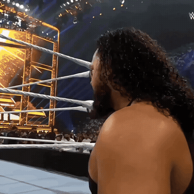 Man With Curly Hair In Wrestling Ring With W Logo GIF