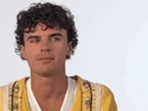 Man With Curly Hair In Yellow Jacket GIF
