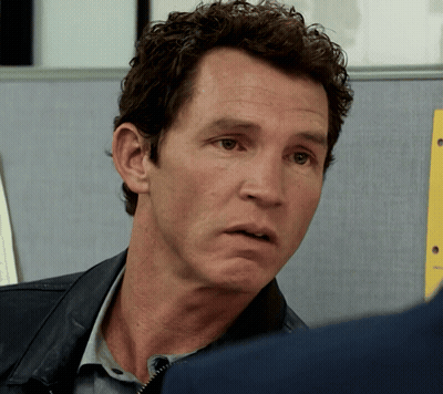 Man With Curly Hair Looking At Another Man GIF