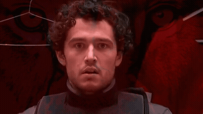 Man With Curly Hair Looking At Camera GIF