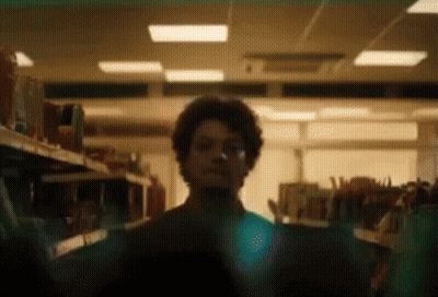 Man With Curly Hair Looking In Store GIF