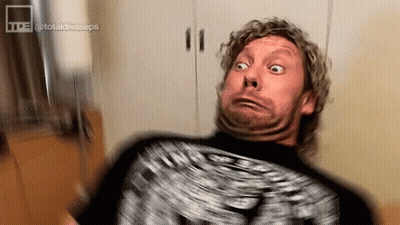 Man With Curly Hair Making Funny Face On Couch GIF