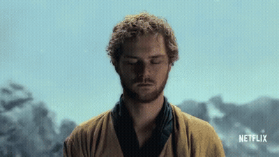 Man With Curly Hair Meditating In Front Of Netflix GIF