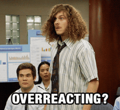 Man With Curly Hair Overreacting In Front of Group