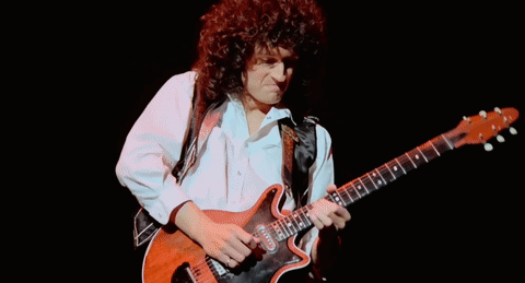 Man With Curly Hair Playing Guitar GIF