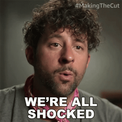 Man With Curly Hair Says We're All Shocked Wearing Pink Scarf GIF