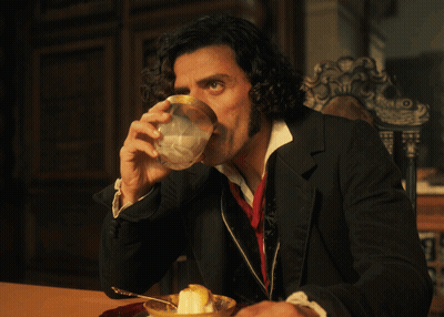 Man With Curly Hair Sitting At Table With Bowl Of Food GIF