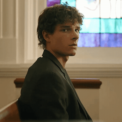 Man With Curly Hair Sitting In Front Of Window GIF