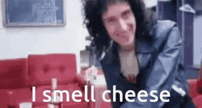 Man With Curly Hair Smelling Cheese GIF