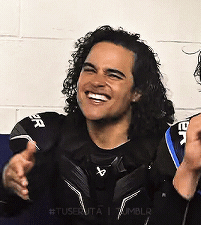 Man With Curly Hair Smiling In Black Shirt GIF