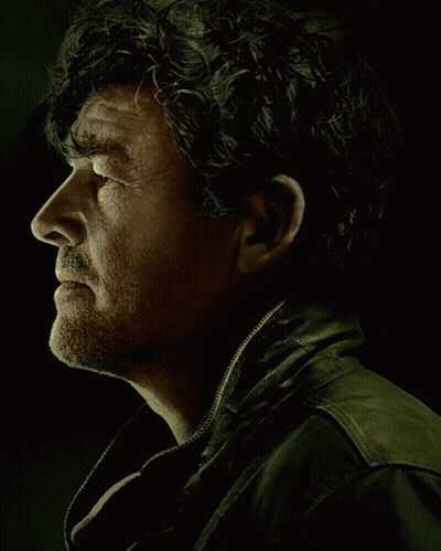 Man With Curly Hair Standing Next To Bearded Man GIF