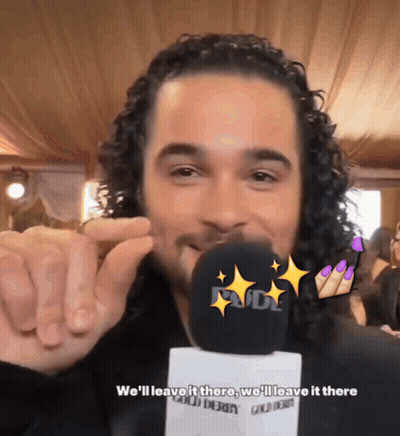Man With Curly Hair Talking Into Microphone GIF