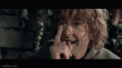 Man With Curly Hair Wearing Cape Holding Green Bag GIF