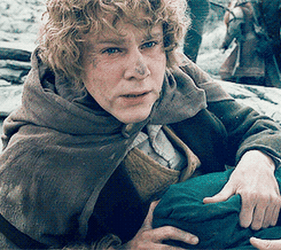 Man With Curly Hair Wearing Cape Holding Green Bag GIF