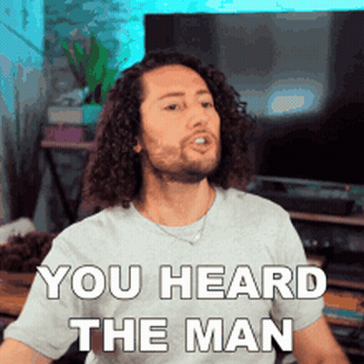 Man With Curly Hair Wearing You Heard The Man T-Shirt GIF