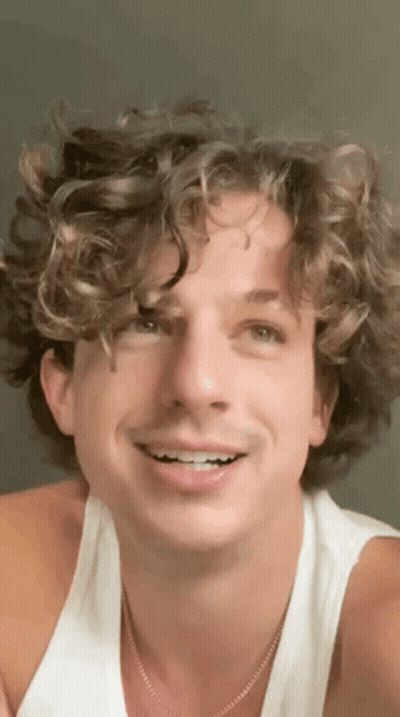 Man With Curly Hair White Tank Top And Necklace GIF