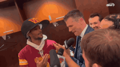 Man With D Hat Interviewed By Suited Man GIF
