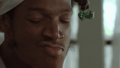 Man With Dice Hanging From Hair GIF