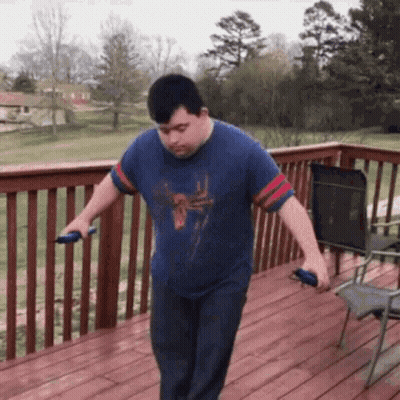 Man With Down Syndrome Jumping Rope On Wooden Deck GIF