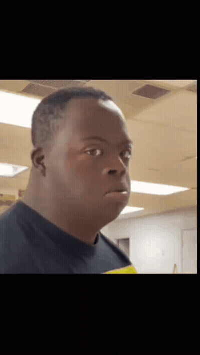 Man With Down Syndrome Making Funny Face In Black Shirt GIF