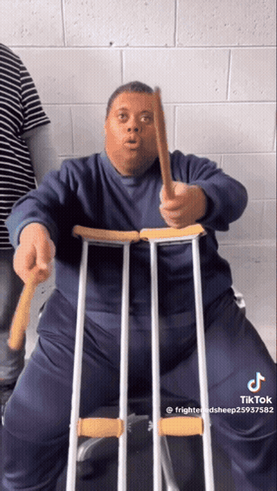 Man With Down Syndrome Making Funny Face In Black Shirt GIF