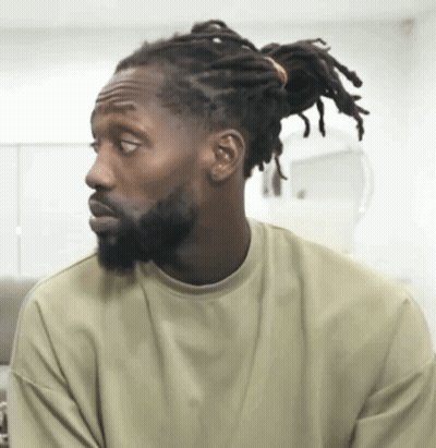 Man With Dreadlocks And Beard Looking Sideways GIF