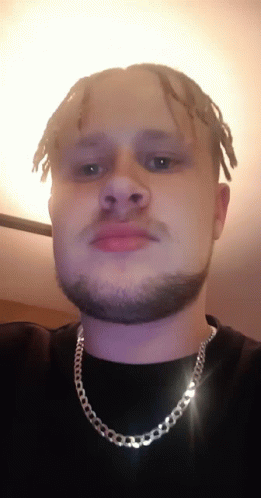 Man With Dreadlocks And Beard Wearing Silver Chain GIF