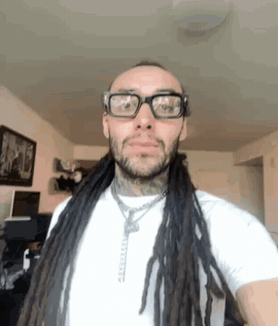 Man With Dreadlocks And Glasses In White Shirt GIF