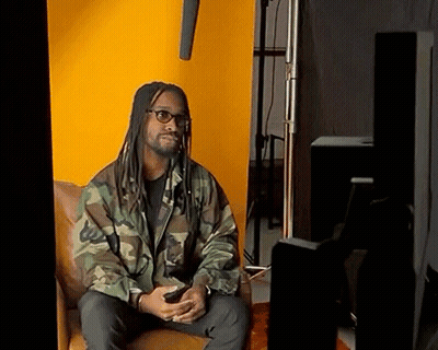 Man With Dreadlocks And Glasses Sitting In Chair GIF