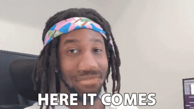 Man With Dreadlocks And Headband Saying Here It Comes GIF